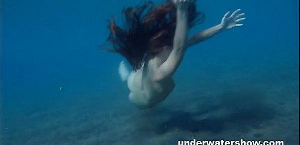  Julia is swimming underwater nude in the sea